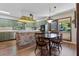 Eat-in kitchen with dark wood floors, brick center island, and retro colored walls and finishes at 446 Alberta Dr, Winter Park, FL 32789