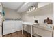 Functional laundry room featuring washer, dryer, sink, and white laminate flooring at 446 Alberta Dr, Winter Park, FL 32789