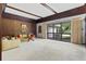 Bright living room with large windows, wood paneling, and comfortable seating for entertaining guests at 446 Alberta Dr, Winter Park, FL 32789