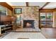 Hardwood floored living room with brick fireplace, large windows and natural light perfect for entertaining at 446 Alberta Dr, Winter Park, FL 32789
