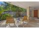 View of a covered patio with neutral furniture, and a view of the fenced garden area at 446 Alberta Dr, Winter Park, FL 32789