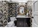 Chic half bathroom boasting marble counters and designer wallpaper at 446 Alberta Dr, Winter Park, FL 32789