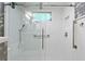 Newly renovated shower with glass door, white tile, and modern fixtures at 446 Alberta Dr, Winter Park, FL 32789