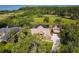 Aerial view of a sprawling estate with pool, lush landscaping, and waterway access at 448 Warrior Trl, Deltona, FL 32725