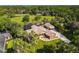 Aerial view of a ranch-style house boasting a large lot, in-ground pool, lush landscaping, and mature palm trees at 448 Warrior Trl, Deltona, FL 32725