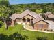 Aerial shot of brick home with meticulous landscaping, walkway, and a lush green lawn at 448 Warrior Trl, Deltona, FL 32725