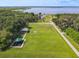 Expansive green space with playground, picnic shelter, and pathway to the lake at 448 Warrior Trl, Deltona, FL 32725