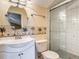 Bathroom featuring a glass-enclosed shower, and a sink with white cabinet, and palm tree-themed wallpaper at 448 Warrior Trl, Deltona, FL 32725