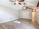 Spacious bedroom featuring wood look tile flooring, a double closet, and two ceiling fans at 448 Warrior Trl, Deltona, FL 32725