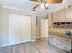 Spacious bedroom features large closets, built-in shelves and drawers, neutral walls, and laminate wood flooring at 448 Warrior Trl, Deltona, FL 32725