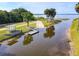 Aerial view of a boat ramp leading into a scenic waterway with surrounding park amenities at 448 Warrior Trl, Deltona, FL 32725