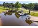 Picturesque boat ramp with a dock, surrounded by lush greenery and trees at 448 Warrior Trl, Deltona, FL 32725