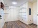 Walk-in closet with wood-look tile flooring, adjustable wire shelving, and an electrical panel at 448 Warrior Trl, Deltona, FL 32725