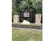 Stone Island entrance sign with stacked stone pillars and lush landscaping at 448 Warrior Trl, Deltona, FL 32725