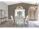 Formal dining room features a modern chandelier, large windows, and tile floors at 448 Warrior Trl, Deltona, FL 32725