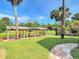 Beautiful backyard view of the covered boat dock with swings and lush landscaping at 448 Warrior Trl, Deltona, FL 32725