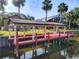 Waterfront property with a private boat dock and covered area for relaxation by the water at 448 Warrior Trl, Deltona, FL 32725