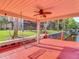 Covered boat dock with a swing, ceiling fan, and waterway view from the backyard at 448 Warrior Trl, Deltona, FL 32725