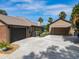 Long driveway leading to multiple garages, set against a blue sky backdrop at 448 Warrior Trl, Deltona, FL 32725