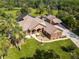 Expansive ranch-style home boasts lush landscaping, attached garage, screened-in pool, and ample curb appeal at 448 Warrior Trl, Deltona, FL 32725