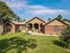 Charming single-story home featuring brick accents, manicured lawn, and inviting curb appeal on a sunny day at 448 Warrior Trl, Deltona, FL 32725