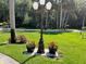 Attractive outdoor lamppost with beautiful flower planters, enhancing the curb appeal of this charming home at 448 Warrior Trl, Deltona, FL 32725