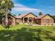 Charming brick home with a well-manicured lawn and inviting front entrance at 448 Warrior Trl, Deltona, FL 32725
