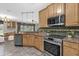 Well-lit kitchen with stainless steel appliances and granite countertops at 448 Warrior Trl, Deltona, FL 32725