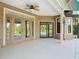 Outdoor lanai showcasing a large concrete deck with views of the pool and lush backyard at 448 Warrior Trl, Deltona, FL 32725