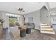 Cozy living room with tile flooring, neutral decor and backyard view at 448 Warrior Trl, Deltona, FL 32725