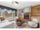 Comfortable living room featuring a fireplace, built-in shelves, and large window views at 448 Warrior Trl, Deltona, FL 32725