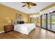 Bright main bedroom with tile floors and a sliding door out to a covered patio at 448 Warrior Trl, Deltona, FL 32725