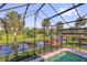 Screened-in pool with stunning views of the pond and surrounding nature at 448 Warrior Trl, Deltona, FL 32725