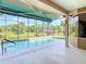 Screened-in pool area with scenic backyard views overlooking the canal and dock at 448 Warrior Trl, Deltona, FL 32725