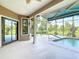 Inviting pool area with screened-in lanai, providing a relaxing outdoor space with views of palm trees at 448 Warrior Trl, Deltona, FL 32725