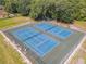 Overhead view of two well-maintained blue tennis courts, perfect for recreational play at 448 Warrior Trl, Deltona, FL 32725