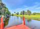 Scenic waterfront view showcases lush landscaping and a serene canal, creating a picturesque and peaceful setting at 448 Warrior Trl, Deltona, FL 32725