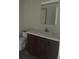 Cozy bathroom with a vanity, white countertop, and a mirrored cabinet at 45814 Lake St, Paisley, FL 32767