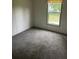 Comfortable bedroom with gray carpet and a bright window allowing natural light at 45814 Lake St, Paisley, FL 32767