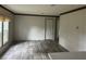 Open living area with wood-look flooring, neutral walls, and a view of adjacent rooms at 45814 Lake St, Paisley, FL 32767