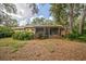 The back of the house has a screened in porch with nice foliage surrounding the perimeter at 4799 Lighthouse Rd, Orlando, FL 32808