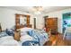 Cozy bedroom with wood floors and large wood dresser at 4799 Lighthouse Rd, Orlando, FL 32808