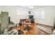 Bedroom with wood floors, chair, desk, and two windows offering natural light at 4799 Lighthouse Rd, Orlando, FL 32808