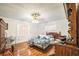 Bedroom with wood floors, two windows, and cozy decor at 4799 Lighthouse Rd, Orlando, FL 32808