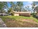 Charming single-story home with a stone facade and well-maintained front yard at 4799 Lighthouse Rd, Orlando, FL 32808