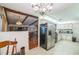 Open kitchen layout with a stainless steel refrigerator, tile flooring, and eat-in area at 4799 Lighthouse Rd, Orlando, FL 32808