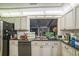 A view of the kitchen with granite counters and stainless steel appliances at 4799 Lighthouse Rd, Orlando, FL 32808