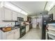 Well-lit kitchen with stainless steel appliances and tiled flooring at 4799 Lighthouse Rd, Orlando, FL 32808
