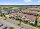 Community aerial view with townhomes, landscaping, parking, and scenic water views at 4802 Lullaby Ln, Kissimmee, FL 34746