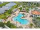 A high angle aerial view of the community swimming pool, dining, and recreation areas near the water at 4802 Lullaby Ln, Kissimmee, FL 34746